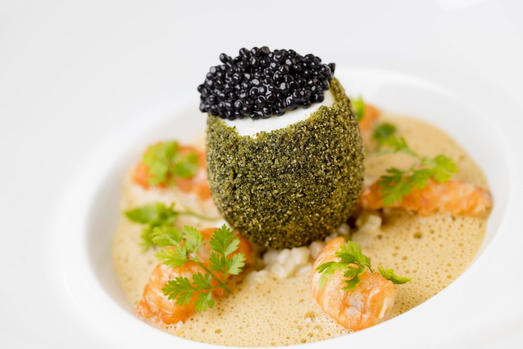 A plated dish topped with caviar