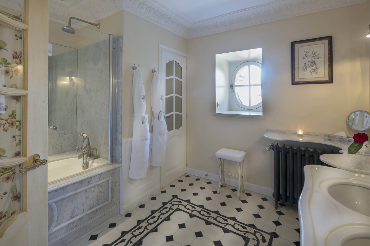 A bathroom with a bathtub and a shower