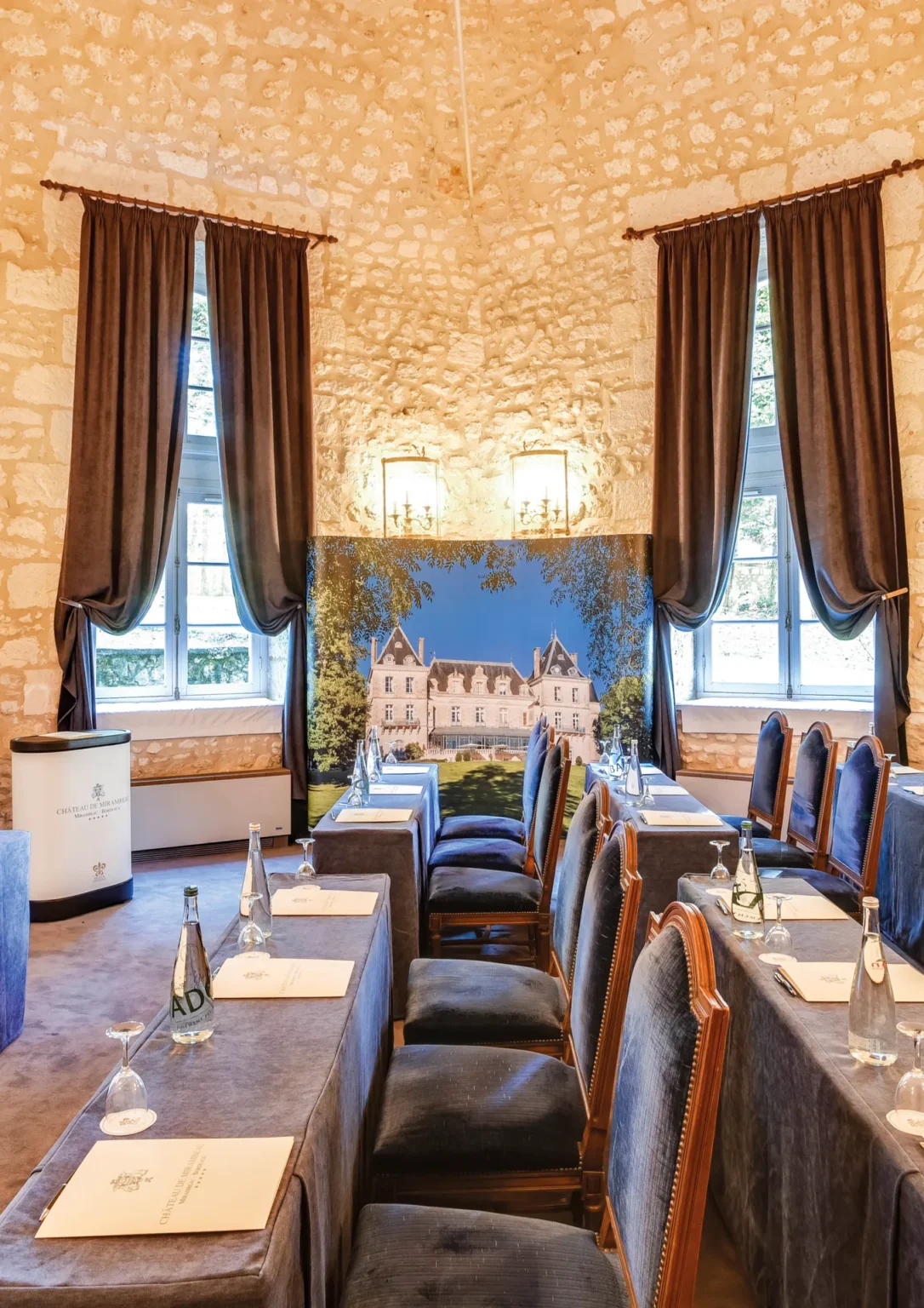 Salon Bordeaux set classroom-style between two tall windows